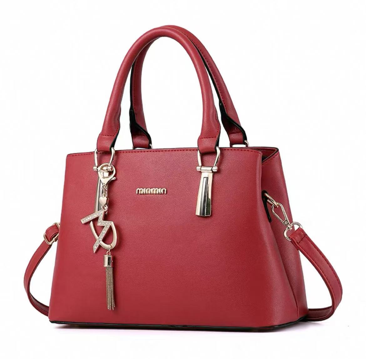 Stylish Handbag with Charm Pendant – Available